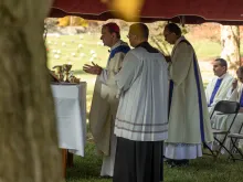 In commemoration of All Souls' Day, Arlington Bishop Michael Burbidge celebrated Mass at a Fairfax cemetery and blessed the gravesites of the priests buried there on Nov. 2, 2022.