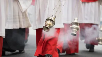 Altar boys swing incense in a procession in Cologne, Germany.