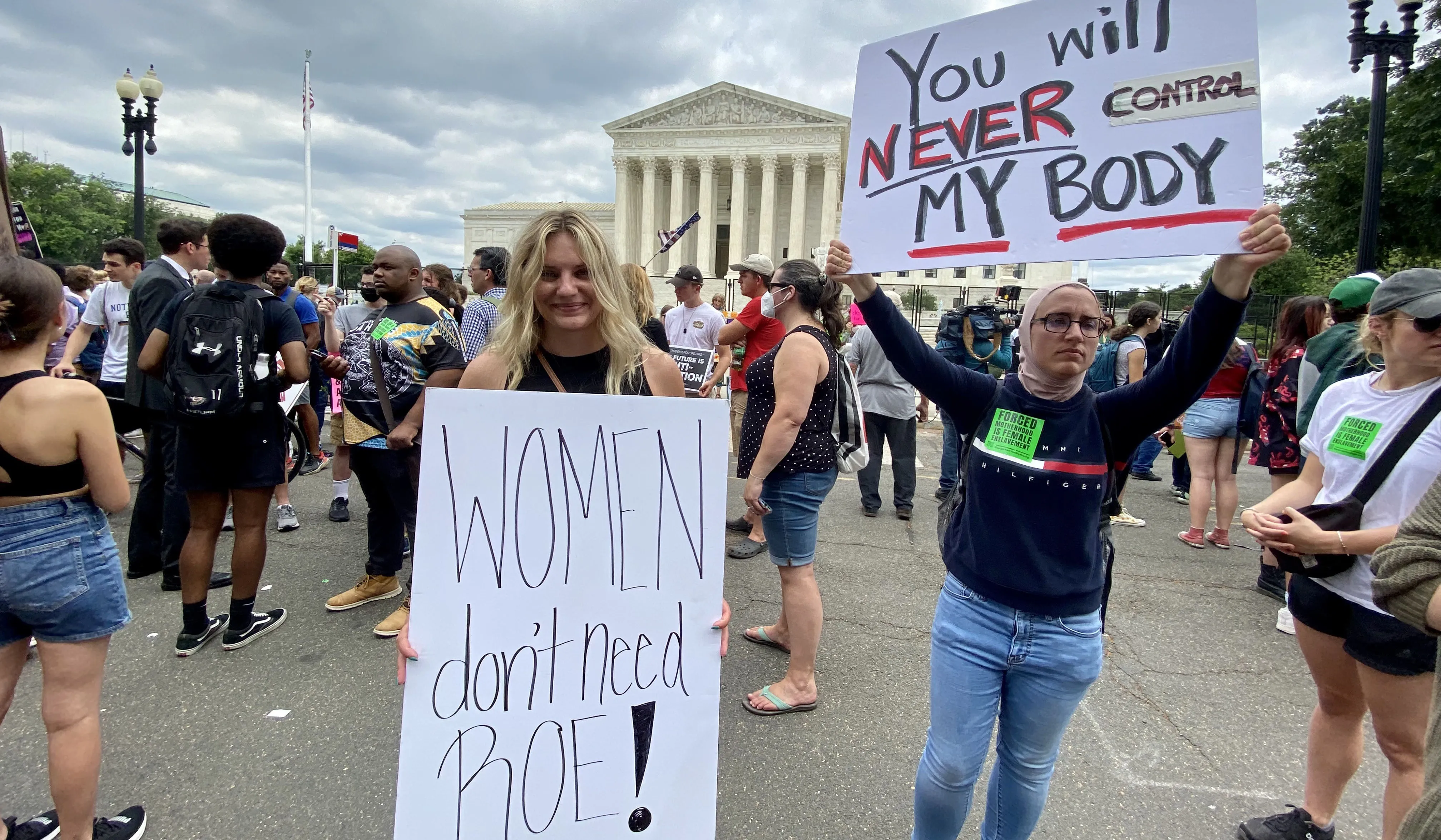 Anna Lulis from Moneta, Virginia, (left) who works for the pro-life group Students for Life of America, stands beside an abortion rights demonstrator outside the U.S. Supreme Court in Washington, D.C., on June 24, 2022, after the court's decision in the Dobbs abortion case was announced.?w=200&h=150