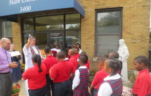 Father Fred Close, pastor of St. Anthony of Padua Catholic Church in Washington, D.C., blesses St. Anthony students after a blessing of the statue. Courtesy photo