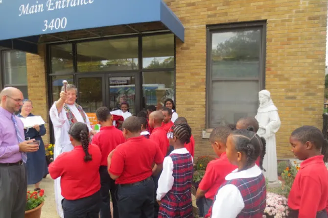 Father Fred Close, pastor of St. Anthony of Padua Catholic Church in Washington, D.C., blesses St. Anthony students after a blessing of the statue.