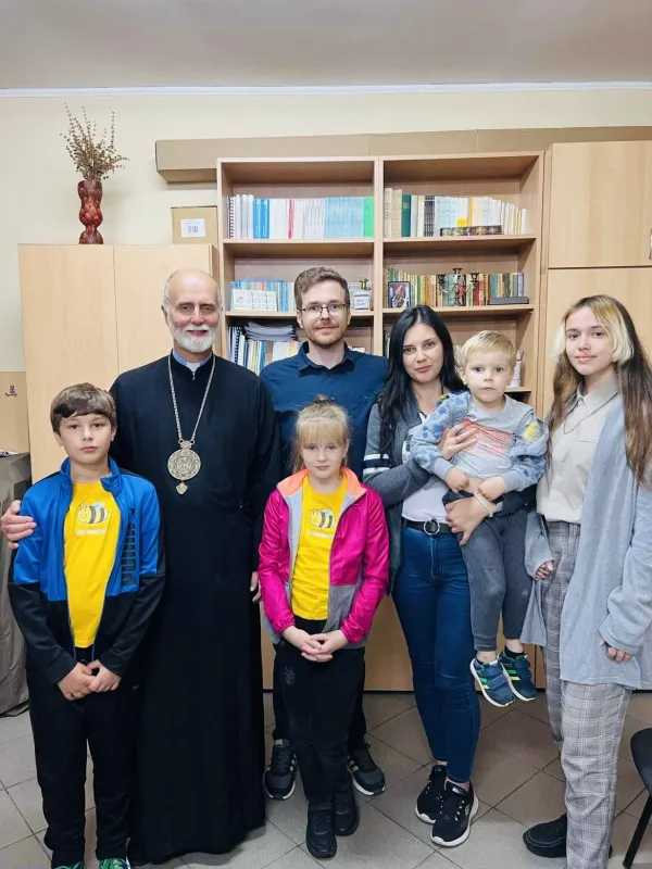 Archbishop Borys Gudziak with a Ukrainian refugee family in Romania. Photo courtesy of Ukrainian Catholic Archeparchy of Philadelphia