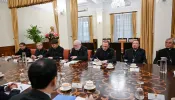 Vatican Secretary for Relations with States Archbishop Paul Gallagher (center) meets with Vietnamc’s Foreign Minister Bui Thanh Son (unseen) and other officials at the Foreign Ministry in Hanoi on April 9, 2024.