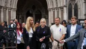 Hollie Dance (center left) and Paul Battersbee (center right)), the mother and father of Archie Battersbee, speak to the media as they leave the Royal Courts of Justice on June 29, 2022 in London, England. Archie's parents ultimately lost their legal fight to keep their son on life support. He died on Aug. 6, 2022.