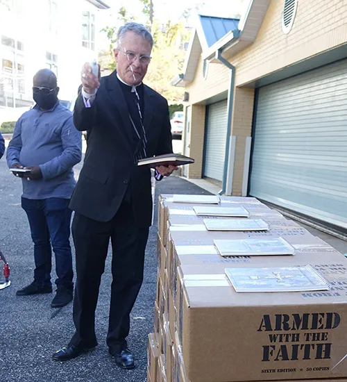 Archbishop Timothy P. Broglio of the Archdioceses for the Military Services blesses copies of the prayer book "Armed With the Faith" on Nov. 9, 2021 in Washington. D.C. Courtesy of the Archdiocese for the Military Services