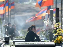 Relatives and friends of those killed in six weeks of fighting for control of the disputed Nagorno-Karabakh region visit the Yerablur Military Memorial Cemetery in Yerevan on Sept. 27, 2022, on the second anniversary of the conflict.