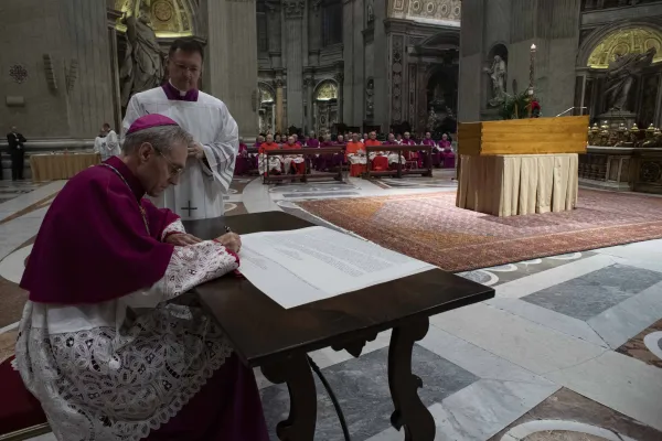 Benedict XVI’s personal secretary Archbishop Georg Gänswein signs an official document after the casket of the former pope was closed during a private ceremony on Jan. 4, 2023, in St. Peter's Basilica. Vatican Media