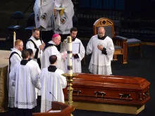 Bishop Carl Kemme of Wichita performs the absolution over the coffin of Fr. Emil Kapaun after his funeral Mass at Hartman Arena in Park City, Kan., Sept. 29, 2021.