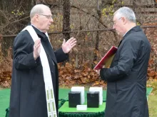 Bishop Robert Deeley leads a committal of unclaimed cremated remains at the Old Cemetery at Calvary in South Portland, Maine, Nov. 22, 2021.