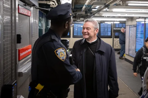 Bishop Robert Brennan is greeted by one of New York’s finest as he arrives at the Court Street Station on April 20, 2024. Credit: Jeffrey Bruno