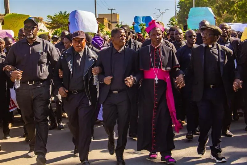 Catholic Archbishop Matthew Ishaya Audu of Jos marches alongside evangelical leader Rev. Dr. Gideon Para-Mallam in front of the Plateau state governor's office building in Jos, Nigeria, Jan. 8, 2024.?w=200&h=150
