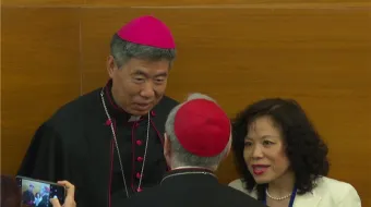 Shanghai Bishop Shen Bin speaks to Vatican Secretary of State Cardinal Pietro Parolin at a Vatican conference on Wednesday, May 22, 2024.