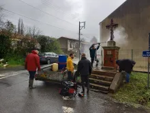 S.O.S. Calvaires, a French lay group, restores a crucifix in France. The group says it aims to restore the artistic and religious heritage of France.