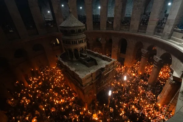 Pilgrims carry candles lit from the "Holy Fire" inside the Basilica of the Holy Sepulcher in Jerusalem on May 4, 2024. Credit: Marinella Bandini/CNA