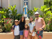 The Cardenas family, of Sacramento, posing outside Maria Lanakila Catholic Church in Lahaina, Hawaii.