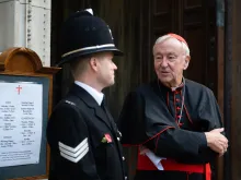 Cardinal Vincent Nichols of Westminster speaks with a police officer outside Westminster Cathedral in London, Nov. 9, 2021.