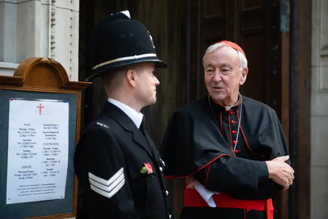 Cardinal Vincent Nichols of Westminster speaks with a police officer outside Westminster Cathedral in London, Nov. 9, 2021.
