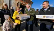 Supreme Knight Patrick E. Kelly, center, and Ukraine State Deputy Youriy Maletskiy give out Easter care packages to Ukrainian refugees in Rava-Ruska, Poland, in April 2022.