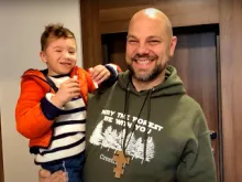 Father Jason Charron with an orphan from Ukraine.