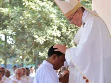 Pope Francis lays hands on a Bangladeshi deacon as he ordains him to the priesthood during a Dec. 1, 2017, Mass in Dhaka.