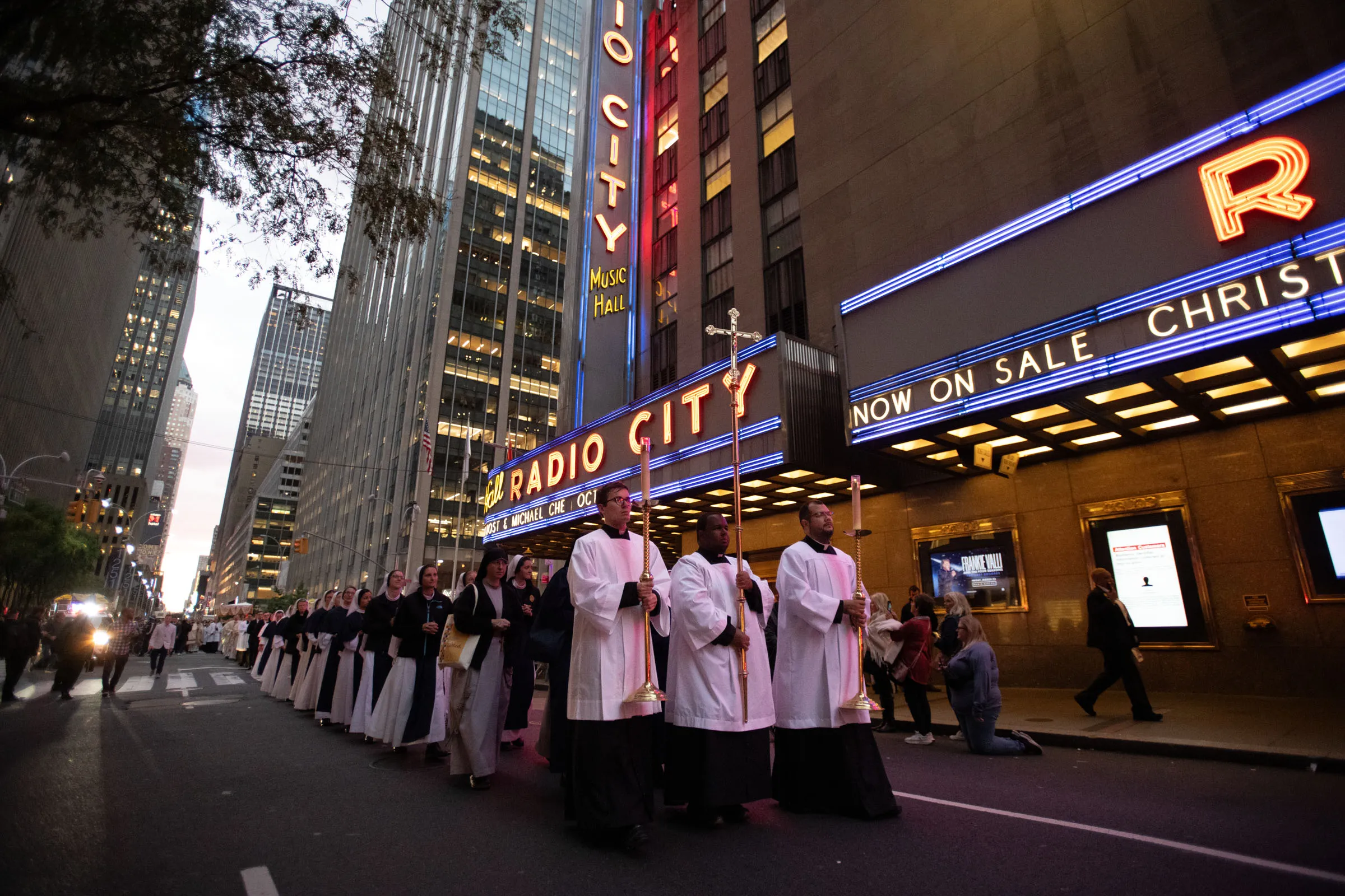 The cross, preceding the Blessed Sacrament, passes by during a Eucharistic procession on the streets of New York City on Oct. 10, 2023.?w=200&h=150