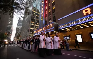 The cross, preceding the Blessed Sacrament, passes by during a Eucharistic procession on the streets of New York City on Oct. 10, 2023. Credit: Jeffrey Bruno