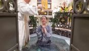 A young woman is baptized at the 2024 Easter Vigil at St. Mary’s Catholic Center at Texas A&M.