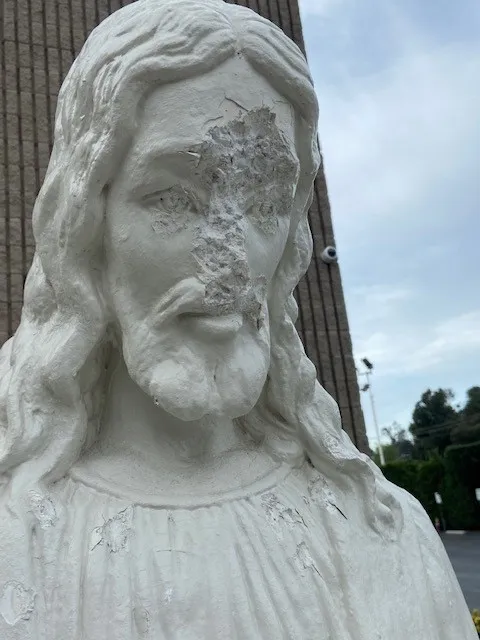 Details of the damaged statues of Jesus at St. Mel's Church in Woodland Hills, California. Photo credit: Michael Stucchi