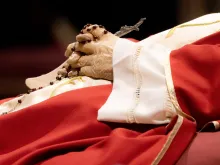 Rosary beads entwined in the hands of the late Pope Emeritus Benedict XVI as his body lies in state on Jan. 3, 2023, in St. Peter's Basilica.