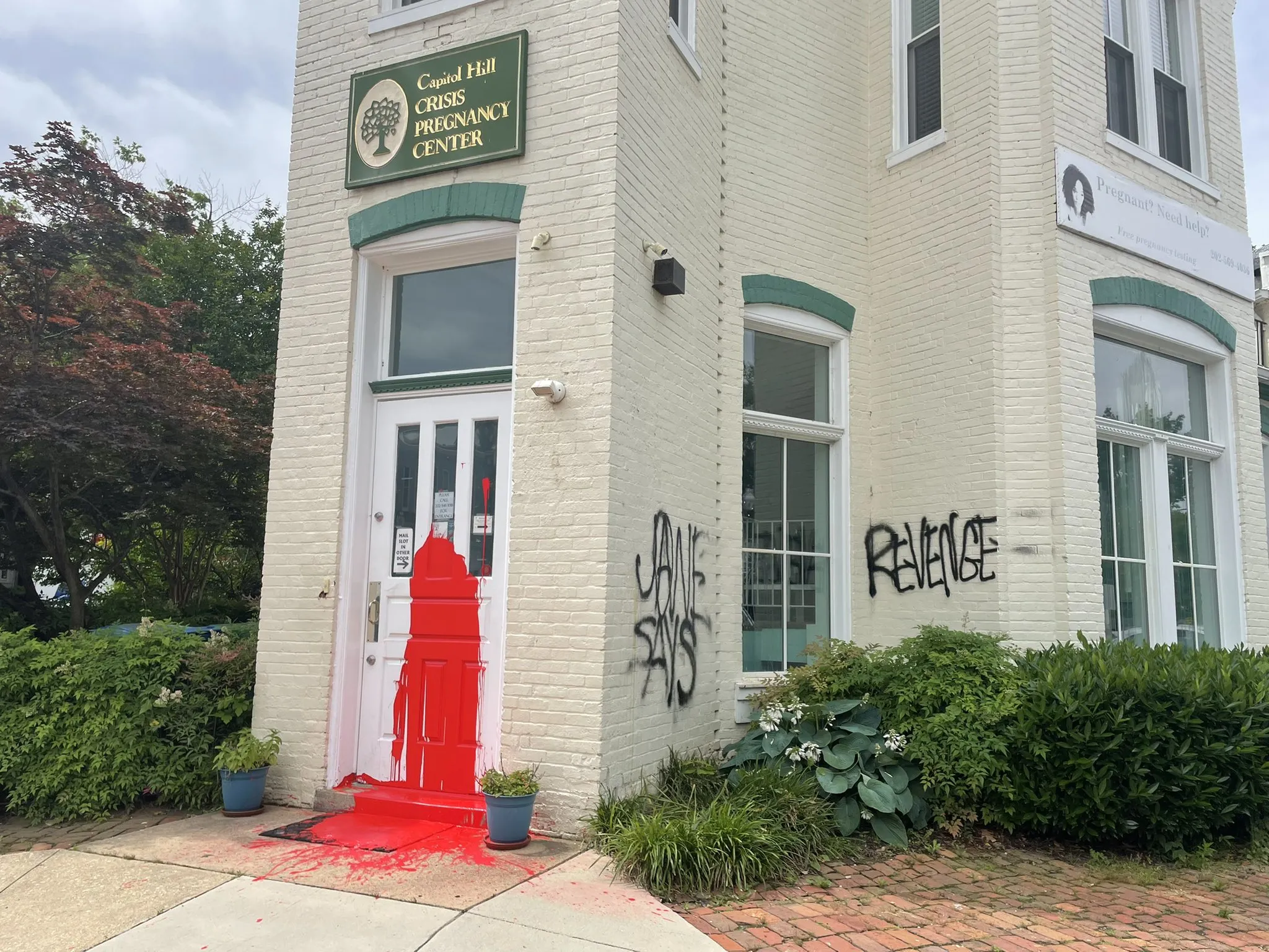 Photos of the June 3 vandalism show a splash of red paint covering the Capitol Hill Pregnancy Center’s white door. On the brick outer building, the words “Jane says revenge” are written in black spray paint.?w=200&h=150