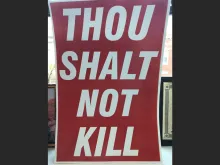 Community activists have begun a campaign to place thousands of signs across the city quoting the sixth commandment, “Thou shalt not kill.”