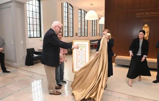 A drawing of the Crucifixion by imprisoned Catholic and pro-democracy activist Jimmy Lai is unveiled by Lai's godfather, William McGurn, and his wife and daughter at The Catholic University of America in Washington, D.C., Feb. 22, 2024. Credit: Patrick G. Ryan/The Catholic University of America