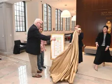 A drawing of the Crucifixion by imprisoned Catholic and pro-democracy activist Jimmy Lai is unveiled by Lai's godfather, William McGurn, and his wife and daughter at The Catholic University of America in Washington, D.C., Feb. 22, 2024.