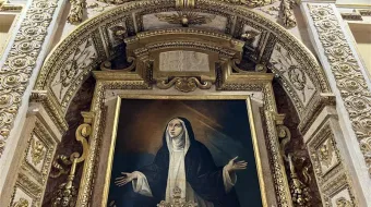The hidden chapel where St. Catherine of Siena died in Rome is located in the Palazzo Santa Chiara on Via di S. Chiara, 14.