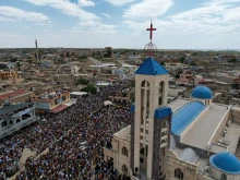 The streets of Qaraqosh — also known as Baghdeda — in Iraq are filled with joy as residents celebrating Palm Sunday carry olive branches and palm fronds in a grand procession of nearly 20,000 Christians on April 13, 2025.