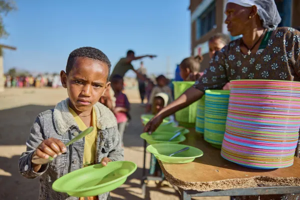 A boy about to be served a meal at Tsehafe Werdi Primary School in Tigray, Ethiopia, in March 2024. The Daughters of Charity, supported by Mary's Meals, has provided meals to thousands of children through a school feeding program since 2017. Credit: Armstrong Studios // 2024