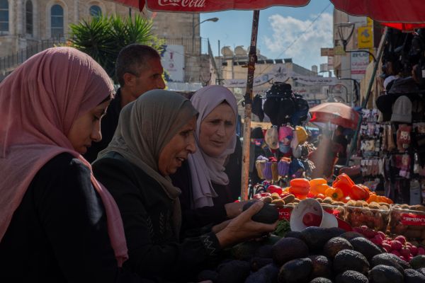 Some women are shopping in the suq (the Arab market) in the old city of Bethlehem, on Saturday, Nov. 18, 2023. Credit: Marinella Bandini