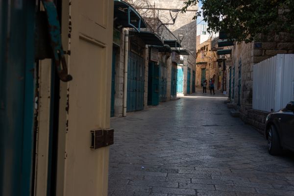 Milk Grotto Street, a few meters from the Basilica of the Nativity, in Bethlehem. The street is lined with souvenirs and local craft shops, all of which are closed today. Credit: Marinella Bandini