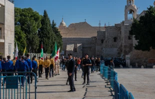 The small procession of Franciscan friars, with the Custos of the Holy Land, arrives in Manger Square, in front of the Basilica of the Nativity, in Bethlehem on Saturday, Dec. 2, the day of the solemn entrance for the beginning of Advent. The Square, typically crowded with local believers and pilgrims, was empty. Dec. 2, 2023. Credit: Marinella Bandini