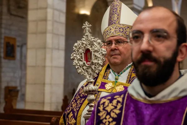 The custos of the Holy Land, Father Francis Patton, enters St. Catherine's Latin Church in Bethlehem, Dec. 2, 2023, for the first vespers of Advent. He carries the relic of the Holy Cradle of the Child Jesus, donated to the Custody of the Holy Land by Pope Francis in 2019. Credit: Marinella Bandini