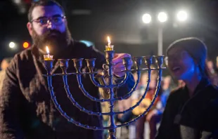 The lighting of the first Hanukkah candle during the interfaith event organized by the Kehilat Zion on the first night of Hanukkah on Dec. 7, 2023, in Jerusalem. Credit: Marinella Bandini