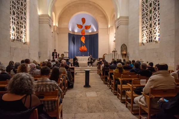 People gathered together on Dec. 12, 2023, in Jerusalem for the interfaith event organized by the Rabbis for Human Rights organization for Hanukkah. The event was hosted by the Church of Scotland at St. Andrew’s Scots Memorial Church. Credit: Marinella Bandini