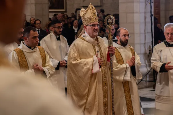 The Latin Patriarch of Jerusalem, Cardinal Pierbattista Pizzaballa, makes his entrance into the Church of St. Catherine in Bethlehem for the celebration of the Christmas Midnight Mass. Dec. 25, 2023. Credit: Marinella Bandini