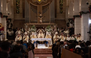 The Latin Patriarch of Jerusalem, Cardinal Pierbattista Pizzaballa, presides over the Christmas Midnight Mass in the Church of St. Catherine in Bethlehem. With him, Cardinal Konrad Krajewski, papal envoy, H. E. Adolfo Tito Yllana, Apostolic Delegate in Jerusalem and Palestine, and the bishops of the Latin Patriarchate of Jerusalem concelebrated. Dec. 25, 2023. Credit: Marinella Bandini