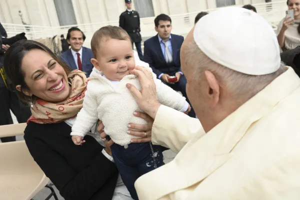 Pope Francis blesses a baby at the general audience on April 5, 2023. Vatican Media