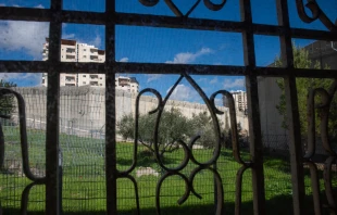 A view of the separation wall between Israel and the Palestinian Territories from behind a window in the Comboni Sisters' house in East Jerusalem. Credit: Marinella Bandini