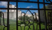 A view of the separation wall between Israel and the Palestinian Territories from behind a window in the Comboni Sisters' house in East Jerusalem.