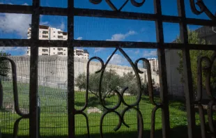 A view of the separation wall between Israel and the Palestinian Territories from behind a window in the Comboni Sisters' house in East Jerusalem. Credit: Marinella Bandini