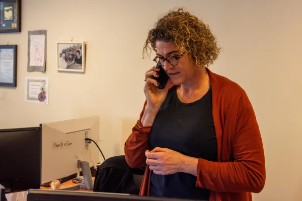 Hana Bendcowsky, program director of the Jerusalem Center for Jewish-Christian Relations (JCJCR), which is part of the Rossing Center for Education and Dialogue, talks on the phone at the office. Credit: Marinella Bandini