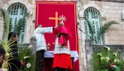 Cardinal Pierbattista Pizzaballa, the Latin Patriarch of Jerusalem, gives the final blessing with the relic of the holy cross at the end of the Palm Sunday procession from Bethphage to Jerusalem on March 24, 2024.